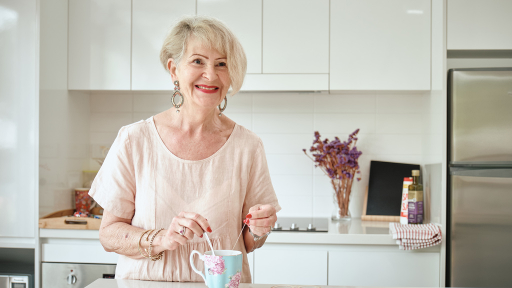 Lady Making Tea In Kitchen