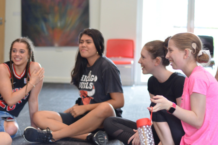 Group Of Teenage Girls Sitting Down Chatting